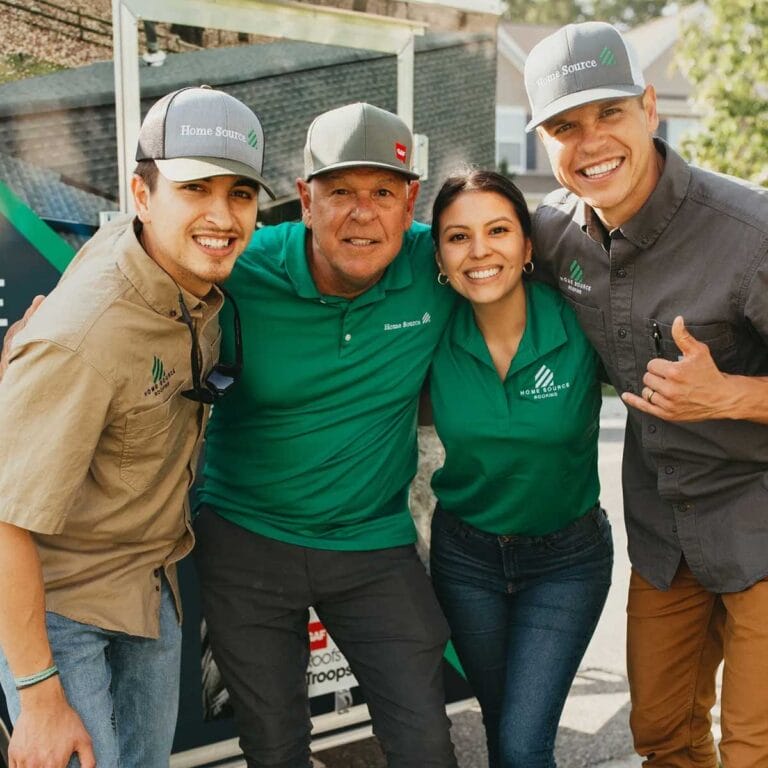 The Home Source Roofing team smiling together at a community event