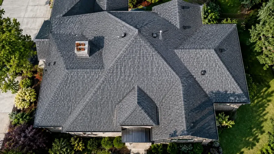 Aerial view of a complex roofline with multiple valleys, a chimney and vent penetrations
